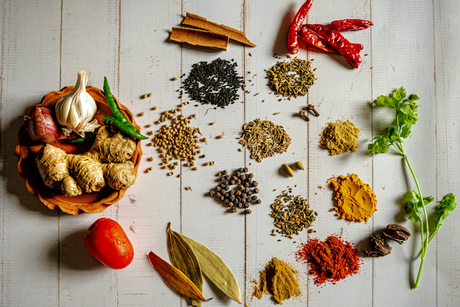 Whole and ground Indian spices with fresh herbs